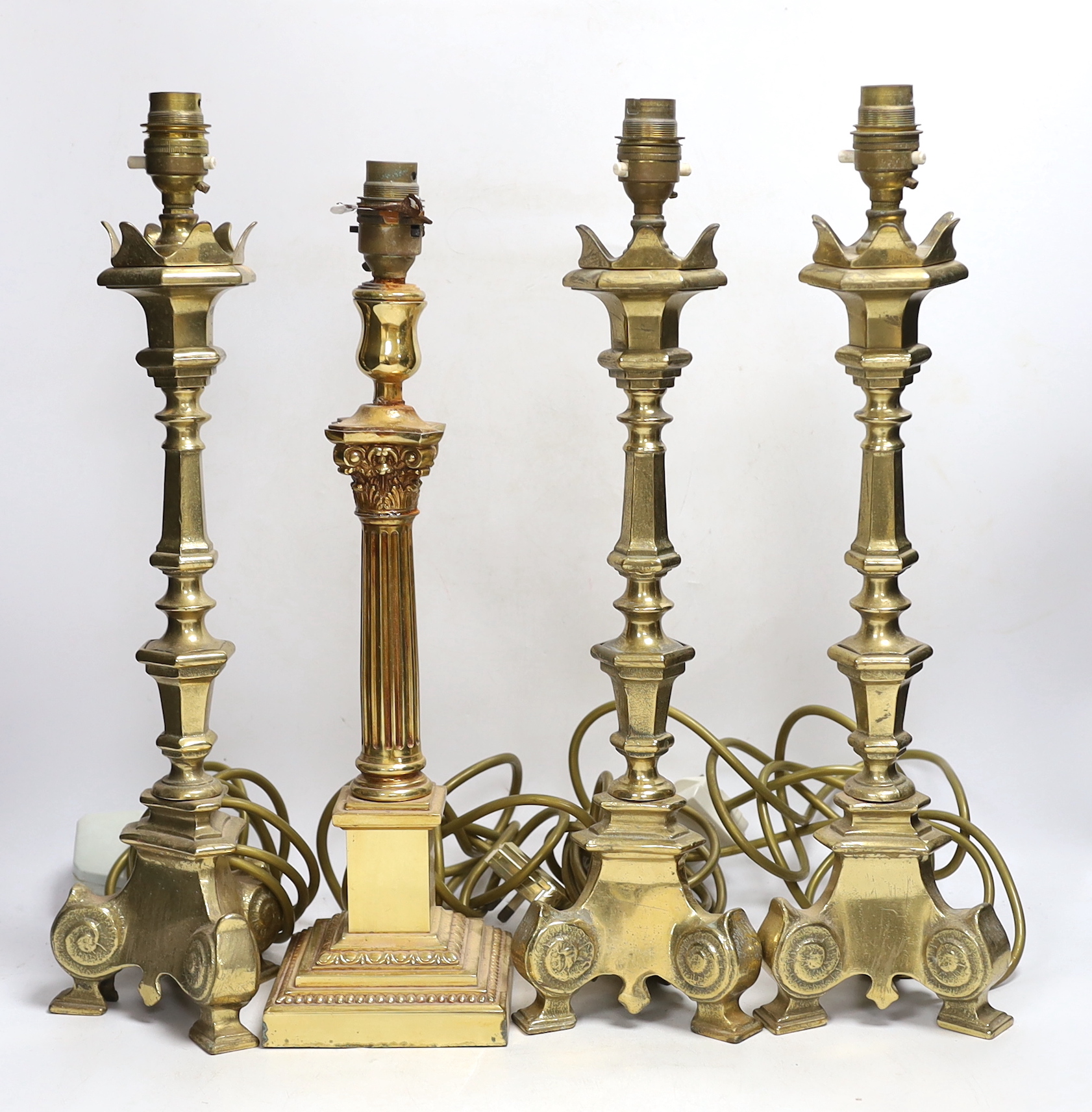 Four brass column lamps including a set of three, largest each 44cm high